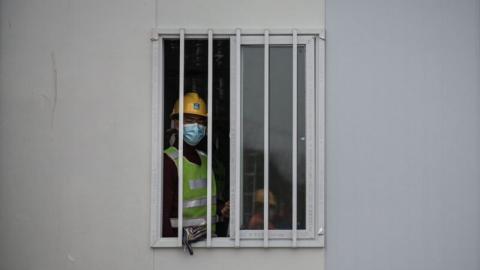 火神山医院如同监狱牢房，病房窗户外焊铁条、钢门。（Getty Images）