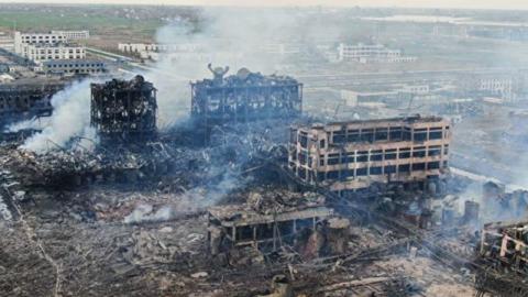 从江苏大爆炸发生16个小时后拍摄的空拍画面可见，该厂区已被完全摧毁，核心区出现巨坑，现场仍有浓烟。(STR/AFP/Getty Images)
